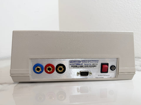 The rear panel of an AMBCO Model 1000+P 32-channel transmitter, featuring red, white, and black RCA inputs, a red power switch, and a serial number label.