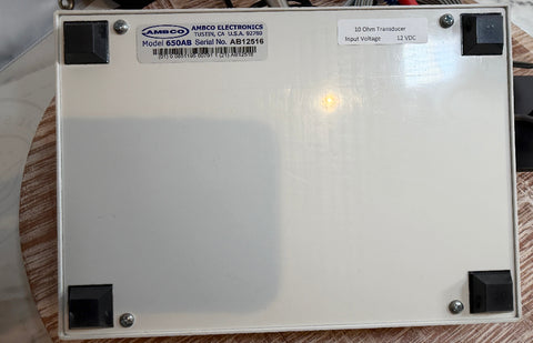 An AMBCO audiometer bottom view showing Model 650AB electronic component with black corner feet and a product label on the top surface.