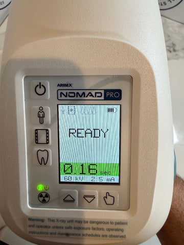 Aribex Nomad Pro Handheld Dental Intraoral System with a screen displaying 'READY' and various icons on a white background.