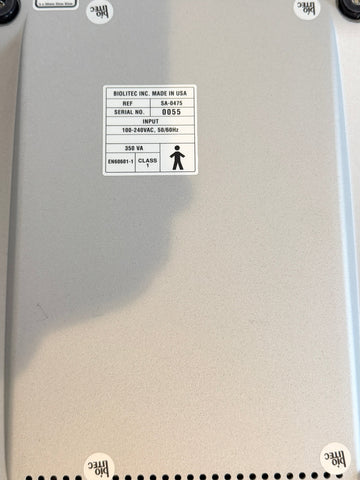 Close-up of the back of a BioLite Ceralas laser device, showing a white Bolitec Inc. product label with specifications and a small human icon.