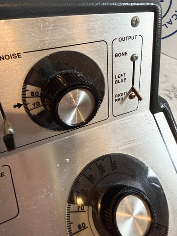Close-up of Beltone 120 Audiometer control panel with knobs and labels.
