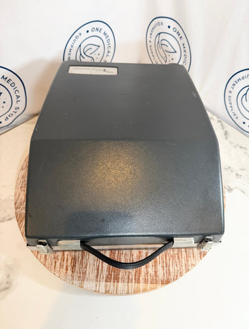 Beltone 120 Audiometer inside black briefcase on a wooden surface 