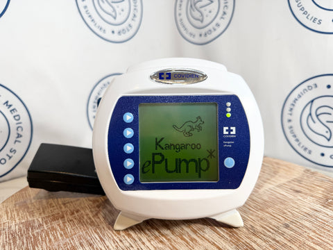 Kangaroo ePump device with Coviden branding on a wooden surface.