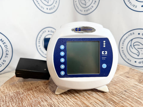 Kangaroo ePump device with digital display on a wooden surface, branded 'Covidien'.
