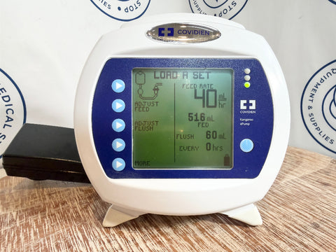 Kangaroo ePump device with digital display on a wooden surface, branded 'Covidien'.