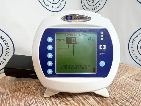 Kangaroo ePump device with digital display on a wooden surface, branded 'Covidien'.