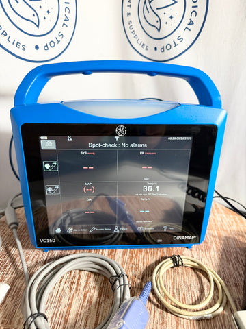 Blue GE Carescape Dinamap VC150 Vital Signs Monitor device with screen displaying readings on a wooden surface.