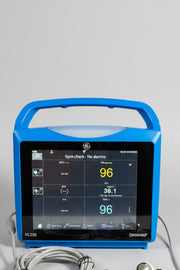 Blue GE Carescape Dinamap VC150 Vital Signs Monitor medical device with GE logo on a wooden surface.