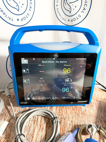 Blue GE Carescape Dinamap VC150 Vital Signs Monitor medical device with GE logo on a wooden surface.