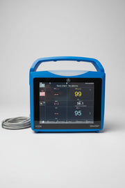 Blue GE Carescape Dinamap VC150 Vital Signs Monitor device with digital display on a wooden surface