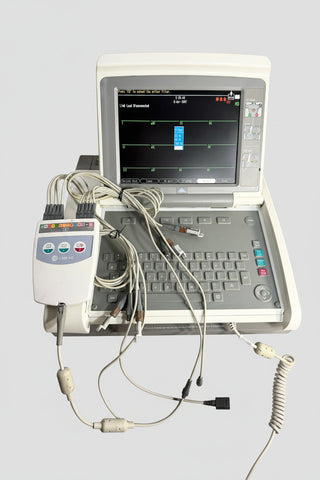 GE EKG machine with an open laptop-style monitor and keyboard, connected to multiple wires and a separate control module.