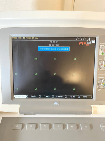 GE Medical MAC 5500 EKG Machine displaying patient data with a blurred screen