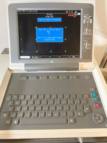 GE Medical MAC 5500 EKG Machine with screen and keyboard on a light background