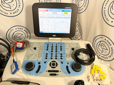 A GSI AudioStar ultrasound machine with a touchscreen display, a gray and light blue control console, attached cables, and a probe, displayed on a white surface with a branded backdrop.