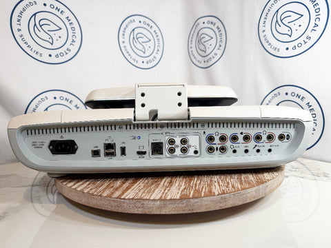The rear panel of a GSI AudioStar Ultrasound machine, resting on a round wooden stand against a white backdrop.