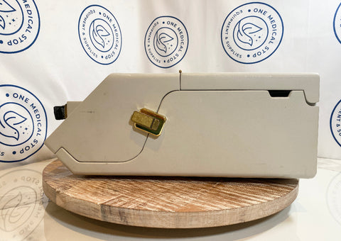 Beige typewriter on a wooden platform with a white background featuring 'One Medical Stop' logos.