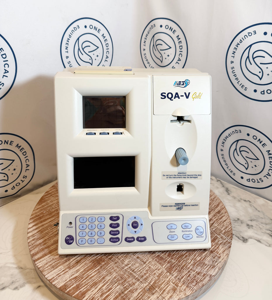 Medical device labeled 'SQA-V' on a wooden platform with a branded background.