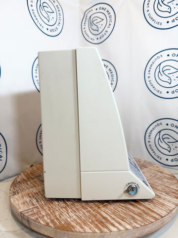 White electronic device on a wooden stand with a branded background