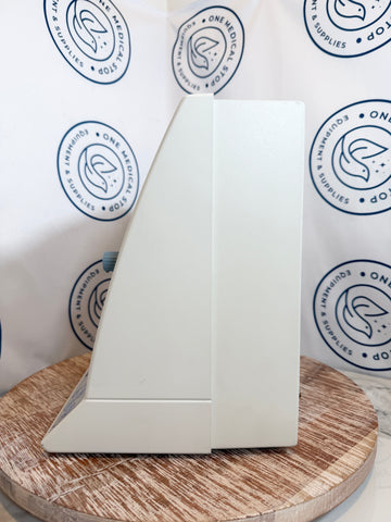 White sailboat model on a wooden surface with a branded background