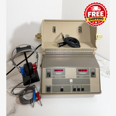 A Maico MA39 Portable Diagnostic Audiometer device with an open beige lid, a gray front control panel with red digital displays, attached cables, and a blue-and-red headset on a white marble surface against a white wall. A red 'FREE SHIPPING' badge is overlaid in the top right corner.
