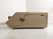 A Maico MA39 Portable Diagnostic Audiometer with gold-toned metal accents, photographed from the side against a white wall and white surface.