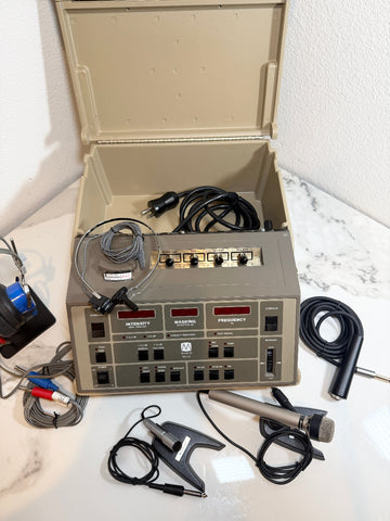 A Maico MA41 Portable Diagnostic Audiometer  device with an open beige carrying case, shown on a white marble surface with various attached cables, a clip-on microphone, and a handheld microphone.