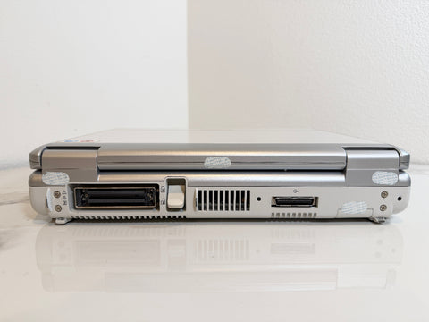 A Mindray portable ultrasound machine  shown closed from the back, displaying ports and vents on a white reflective surface against a white wall.