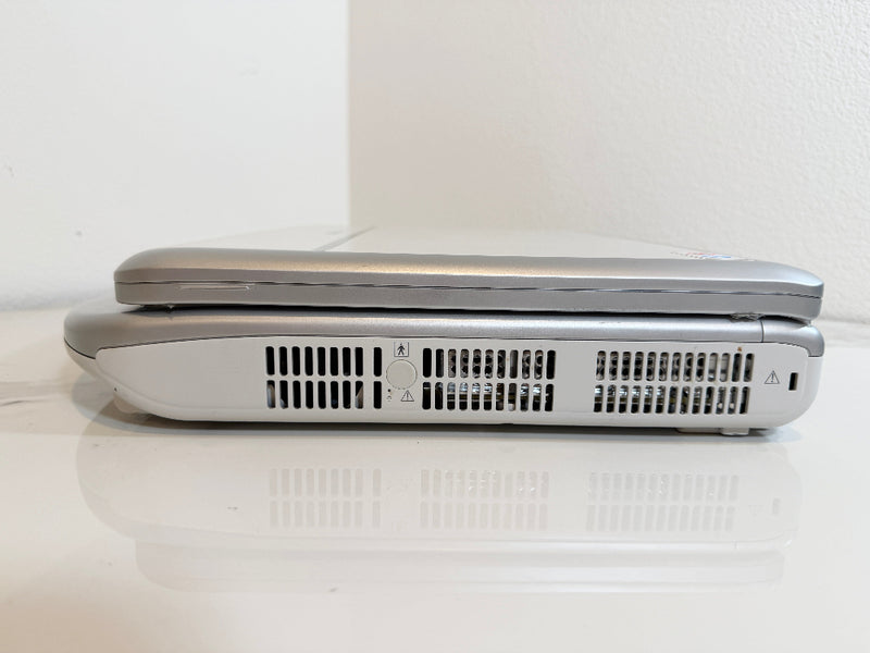 A Mindray portable ultrasound machine shown closed from the side, resting on a white reflective surface against a white wall.