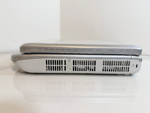 A Mindray portable ultrasound machine shown closed from the side, resting on a white reflective surface against a white wall.