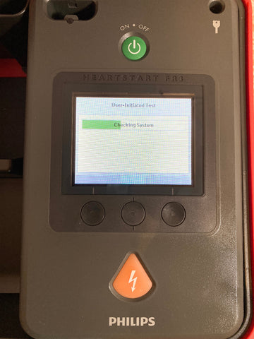 Philips Heartstart FR3 AED Defibrillator with a power button and display screen.