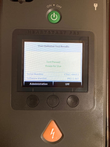 Philips Heartstart FR3 AED Defibrillator with a screen displaying test results.