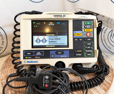 Medtronic Lifepak 20 defibrillator on a wooden surface with a white background