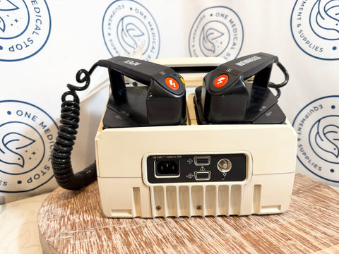Medical device with two black components on a wooden surface, branded background.