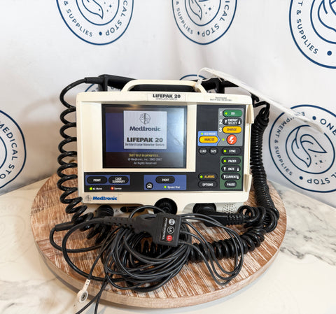 Medtronic Lifepak 20 defibrillator on a wooden stand with visible branding.