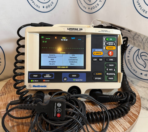 Heart monitor device on a wooden surface with a branded background