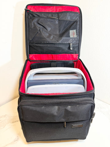 Siemens Acuson Cypress Portable Ultrasound in an open black hard-shell travel case with a bright pink interior lining, shown on a light marble-like surface against a white wall.