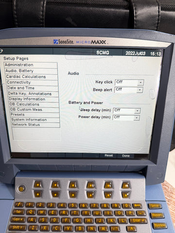 A handheld SonoSite MicroMaxx Portable Ultrasound System monitor showing the user interface on screen, with a blue and gray keyboard and black handle visible.