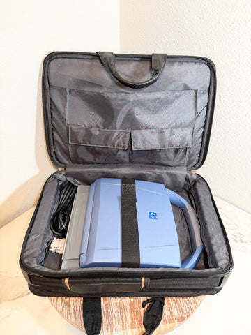 A blue and gray SonoSite MicroMaxx Portable Ultrasound System, secured inside an open black soft-sided carrying case with padded interior compartments.