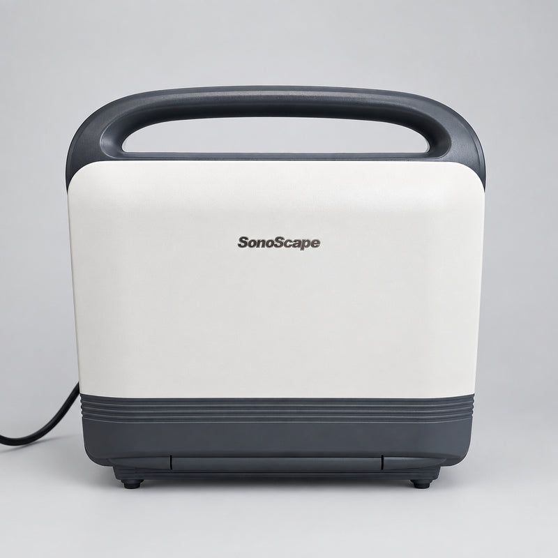 A SonoScape portable ultrasound machine with a cream-colored body, dark gray handle and base, sitting on a wooden surface against a white wall.