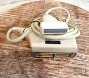 Sonoscape ultrasound ultrasound probe with a beige cable and handpiece, resting on a round wooden surface.