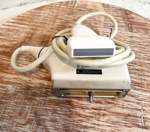 Sonoscape ultrasound ultrasound probe with a beige cable and handpiece, resting on a round wooden surface.