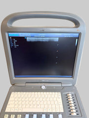 A portable Sonoscape ultrasound machine with a gray plastic housing, beige keyboard, and a black screen displaying medical imaging, set on a wooden surface against a light wall.