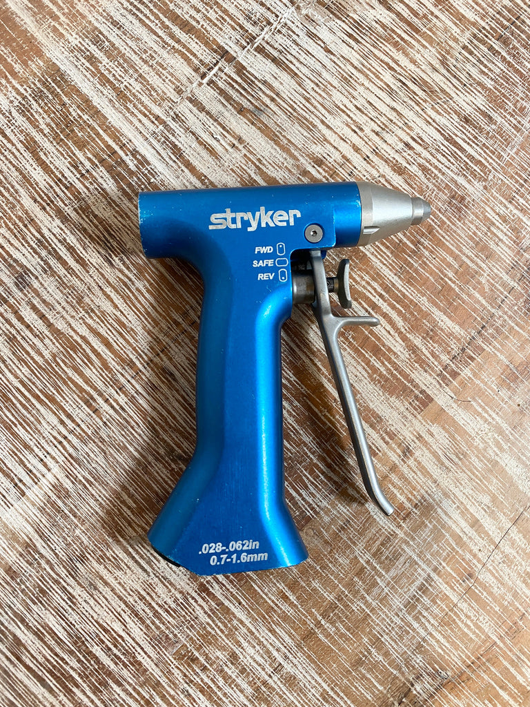 Blue and silver Stryker gun on a wooden surface