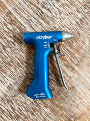 Blue Stryker gun on a wooden surface