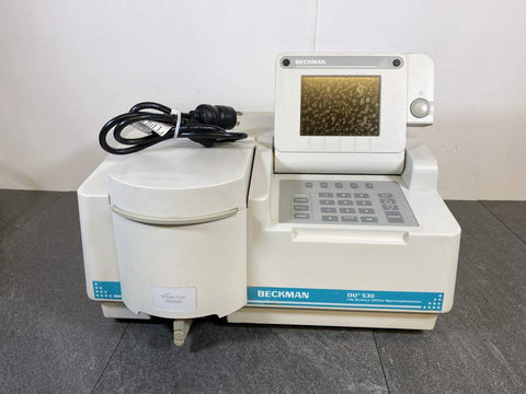 Front picture of the Beckman DU-530 Spectrophotometer UV/VIS with a power cord placed on it