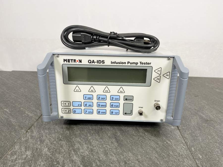 Front picture for Metron QA-IDS Infusion Pump Tester Analyzer with a power cord placed on top 