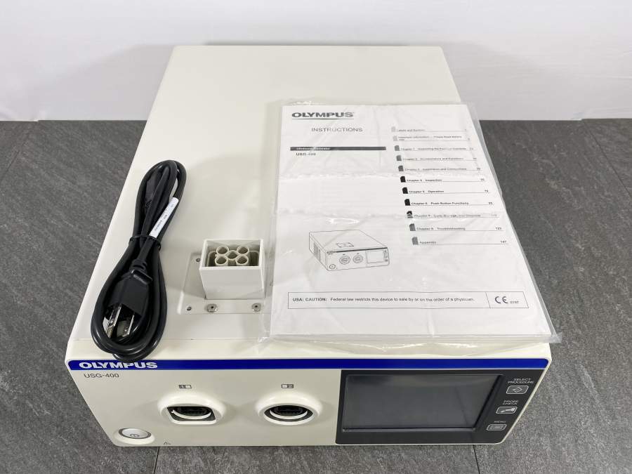 Picture of the Surface for Olympus USG-400 Ultrasonic Generator with one power cord and a user manual placed on it