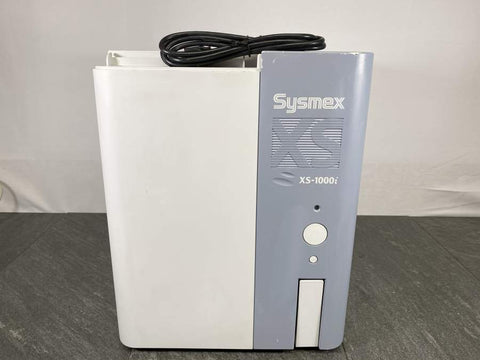 Picture of the Sysmex XS-1000i Automated Hematology Analyzer  with a power cord placed on top