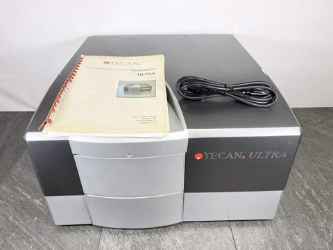 Front picture for Tecan Ultra Multifunctional Microplate Reader  with a Manual and Power Cord placed on top